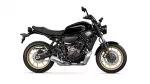 Black Yamaha sport motorcycle shown in profile with gold wheels and exposed engine components, facing right
