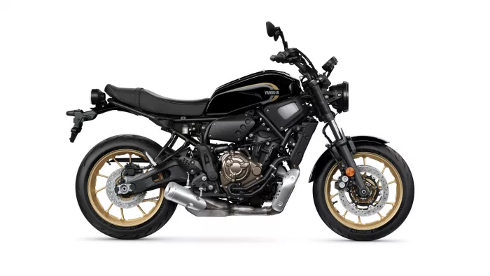 Black Yamaha sport motorcycle shown in profile with gold wheels and exposed engine components, facing right