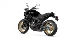 Black Yamaha sport motorcycle shown in a left-side profile with black body and gold rims on a white background.