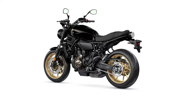 Black Yamaha sport motorcycle shown in a left-side profile with black body and gold rims on a white background.