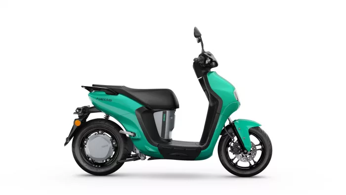 Teal Yamaha Neo's scooter shown from the side, highlighting the sleek body and seat.
