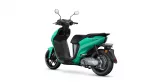 Side view of teal Yamaha Neo's motor scooter with black seat and exposed rear wheel area