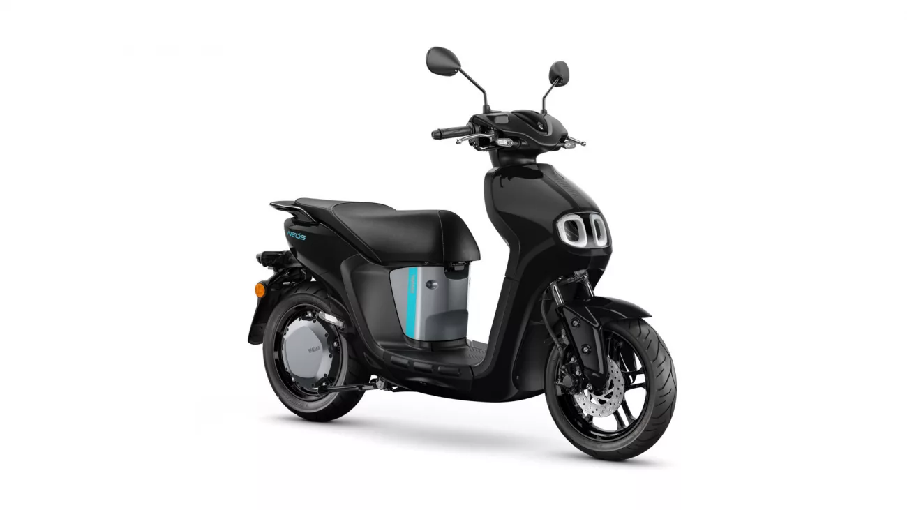 Black electric scooter shown in a right-side profile, with a teal accent panel and dual front lights on a white background.