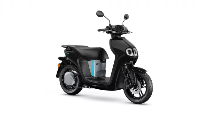 Black electric scooter shown in a right-side profile, with a teal accent panel and dual front lights on a white background.