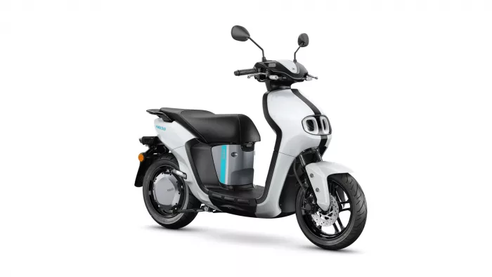 White and black scooter shown from a side angle with turquoise accent stripe on the body and large wheels.