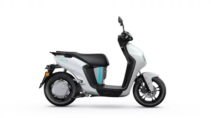 Side view of a silver and black Yamaha scooter with a blue accent stripe and black seat, shown from the left side