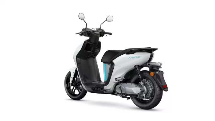 White and black scooter from a rear-side angle, showing the seat, body panels, and rear wheel.