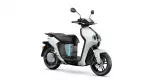 White and black modern scooter photographed from the front-right side, showing the handlebars and mirrors.
