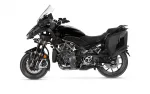 Black sport-adventure motorcycle with a tall windshield and side panniers on a white background