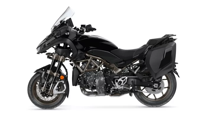 Black sport-adventure motorcycle with a tall windshield and side panniers on a white background