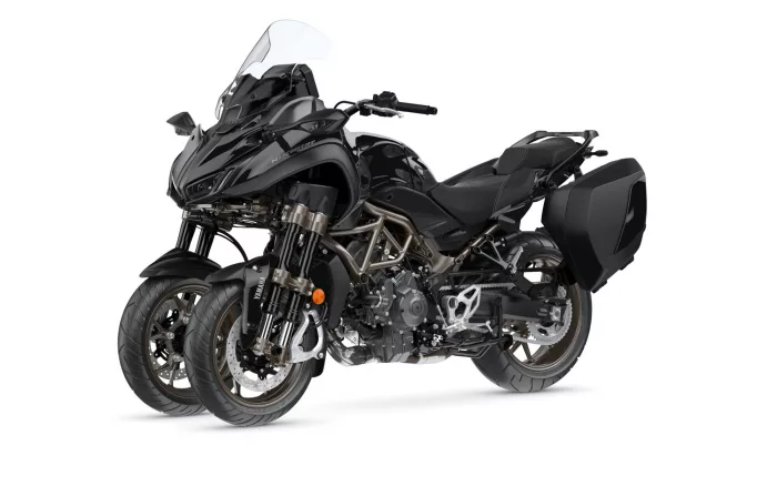 Black adventure/sport-touring motorcycle with large windscreen and hard side panniers on a white background