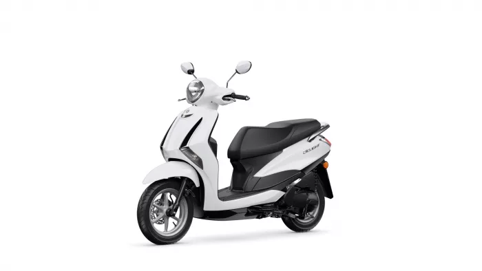 White scooter photographed from a front-left angle, showcasing its headlight and mirrors against a white background.