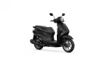 Black modern scooter photographed from a front-right angle, showing the headlight, mirrors, and two-wheeled body on a white backdrop.
