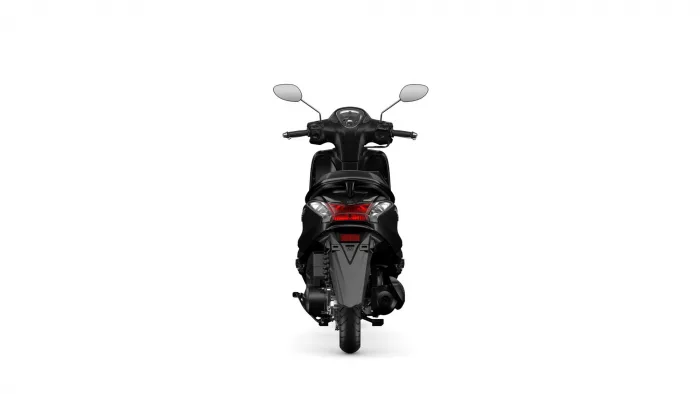 Rear view of a black motorcycle with dual mirrors and red taillight, centered in white space at the back of the bike edge-to-edge view.