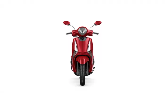 Front view of a red scooter facing the camera, headlight centered and mirrors extended