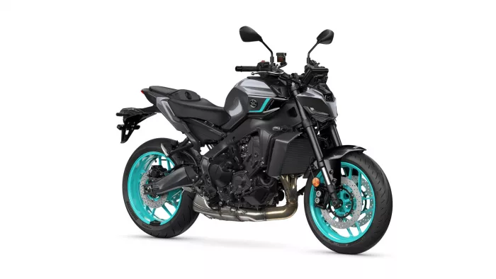 Side view of a modern sport motorcycle with teal turquoise wheels and a dark gray/black body.