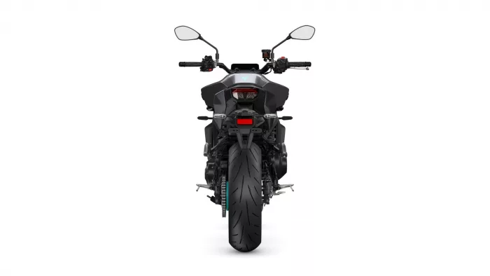 Rear view of a black sport motorcycle with a wide tire, taillight, and mirrors on a white background.