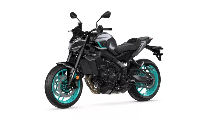 Side view of a black and gray sport motorcycle with teal rims on a white background, highlighting its angular design and exposed engine components.