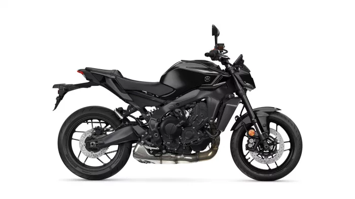 Black sport motorcycle shown in a left-side profile, highlighting the engine, exhaust, and disc brakes against a white background