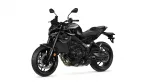 Black sport motorcycle shown from the left side with angular fairings and exposed engine components, Yamaha branding visible on the tank.