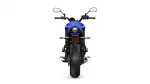 Rear view of a blue sport motorcycle showing a wide rear tire, round tail light, and prominent exhaust beneath the seat from the back perspective with side mirrors visible