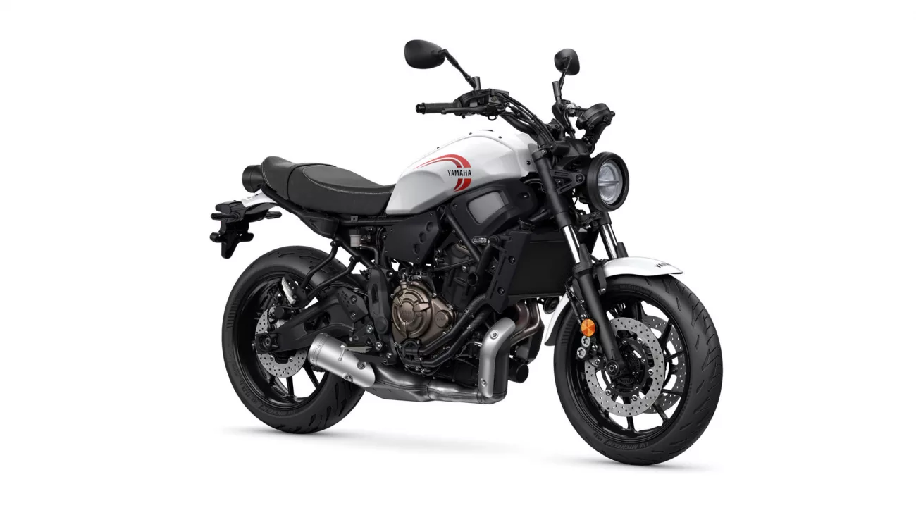 White Yamaha sport motorcycle shown from the side, highlighting the engine, frame, and front wheel.