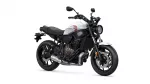 White Yamaha sport motorcycle shown from the side, highlighting the engine, frame, and front wheel.