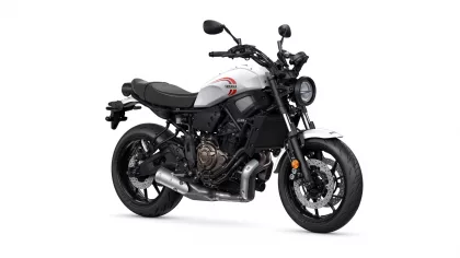 White Yamaha sport motorcycle shown from the side, highlighting the engine, frame, and front wheel.