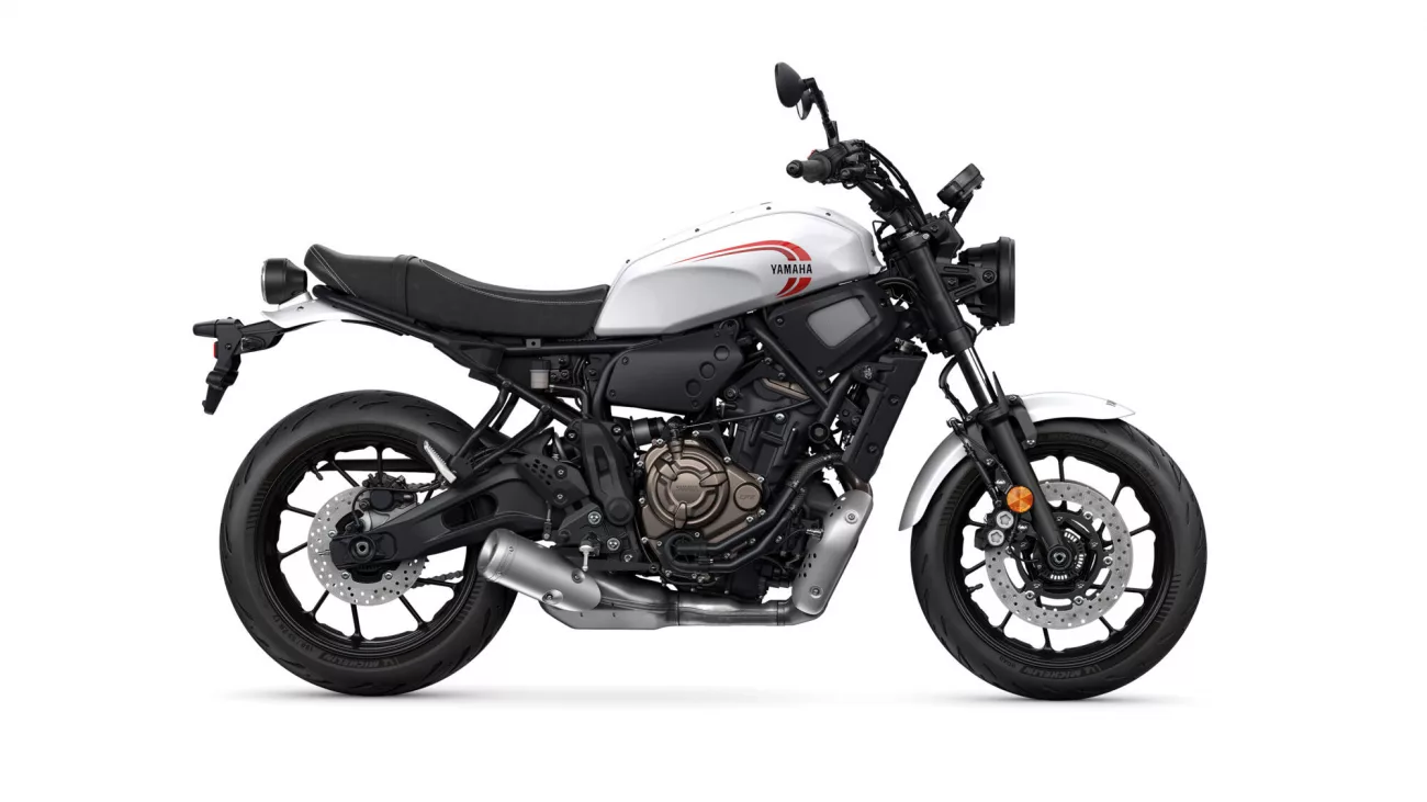 Side view of a white Yamaha sport motorcycle with a black frame and red logo on the fuel tank
