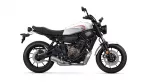 Side view of a white Yamaha sport motorcycle with a black frame and red logo on the fuel tank