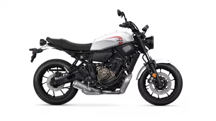 Side view of a white Yamaha sport motorcycle with a black frame and red logo on the fuel tank