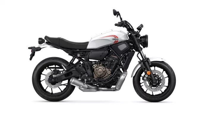 Side view of a white Yamaha sport motorcycle with a black frame and red logo on the fuel tank