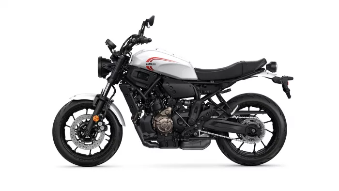 Yamaha sport motorcycle shown in white and black, side profile with red stripe on the fuel tank and exposed mechanical details