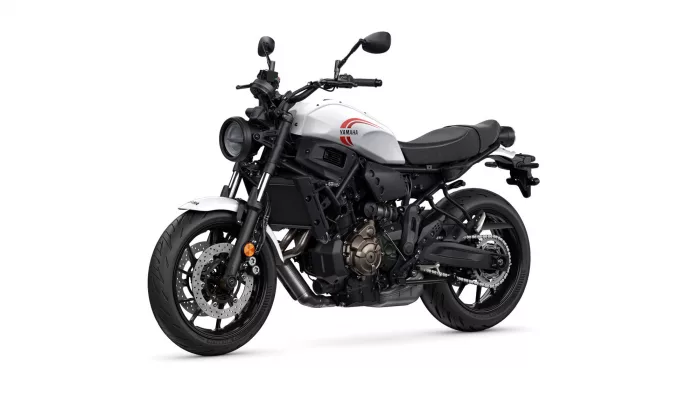 White Yamaha motorcycle shown from a left-front three-quarter angle, highlighting the white fuel tank with red logo and black engine/frame.