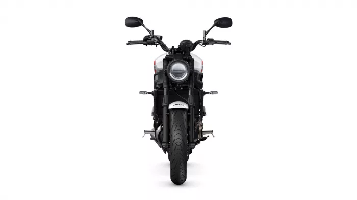 Front view of a Yamaha motorcycle facing the camera, with a large round headlight centered and black mirrors above the handlebars.