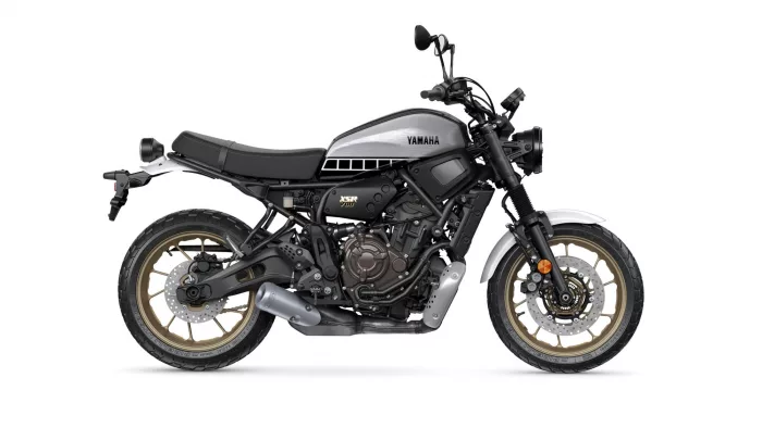 Side view of a Yamaha XSR 700 motorcycle with a silver fuel tank and black frame, shown in profile on a white background.