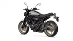 Side view of a Yamaha XSR700 motorcycle with a silver fuel tank, black frame, and gold wheels photographed against a white background.