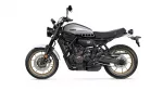 Side view of a Yamaha XSR700 motorcycle with a silver fuel tank, black frame, and gold alloy wheels.