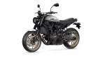 Yamaha XSR700 motorcycle photographed from a front-right side view, with a silver fuel tank, black frame, and gold wheels on a white background.