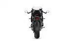Rear view of a black sport motorcycle on a white background, showing taillight, mirrors, and wide rear tire