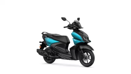 Turquoise-and-black Yamaha scooter shown from the front-right side, highlighting its windshield and headlight.