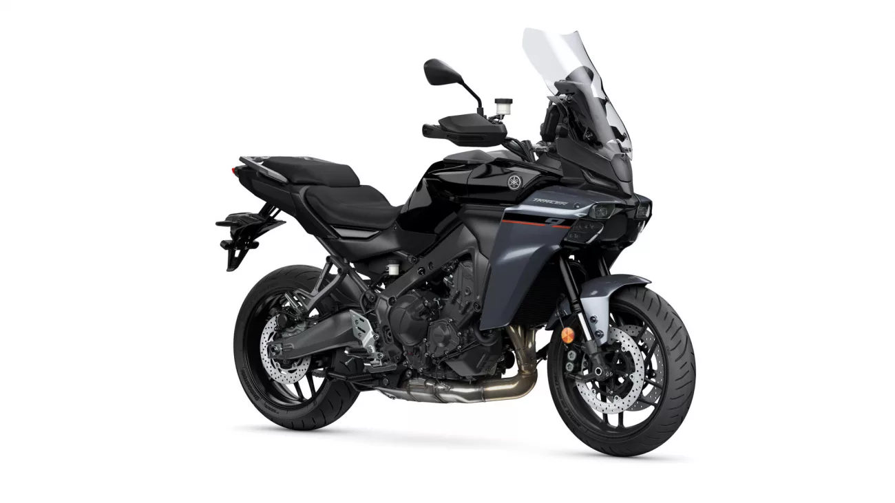 Black Yamaha Tracer sport-touring motorcycle viewed from the front-right with a tall windshield and exposed engine.