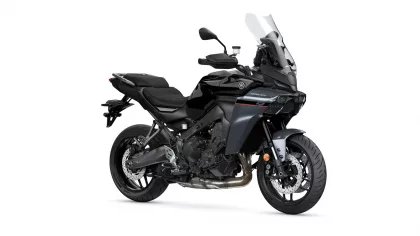 Black Yamaha Tracer sport-touring motorcycle viewed from the front-right with a tall windshield and exposed engine.