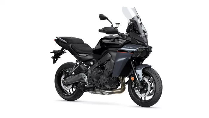 Black Yamaha Tracer sport-touring motorcycle viewed from the front-right with a tall windshield and exposed engine.