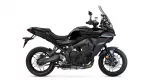 Side view of a black Yamaha Tracer sport-touring motorcycle with a tall windshield and visible front brake discs
