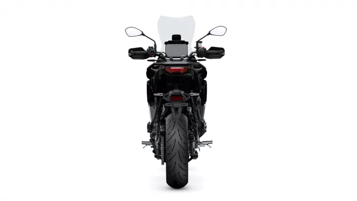 Rear view of a black motorcycle with a tall windscreen, side mirrors, and taillight seen from behind