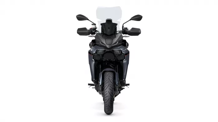 Front view of a dark gray adventure motorcycle with a tall windshield, dual headlights, and side mirrors