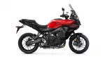 Red Yamaha Tracer sport-touring motorcycle shown in side profile with tall windshield and black chassis.