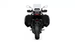 Rear view of a black touring motorcycle with large side panniers and a tall windshield