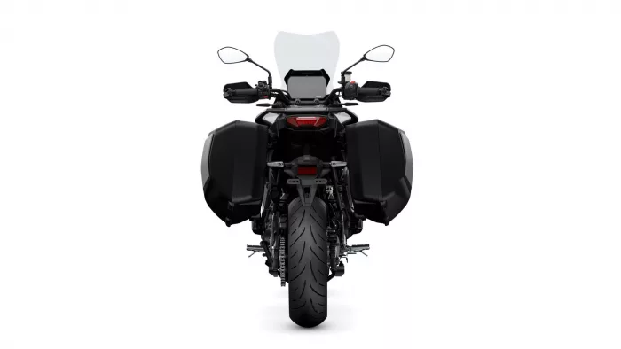 Rear view of a black touring motorcycle with large side panniers and a tall windshield
